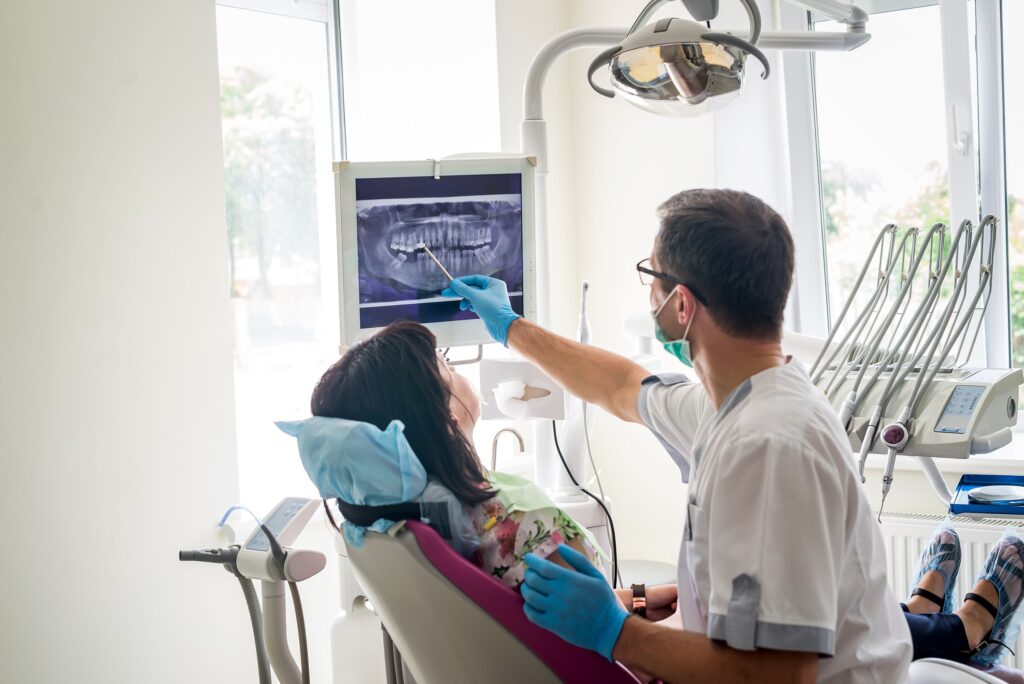 image of a dentist showing a patient a xray of their teeth